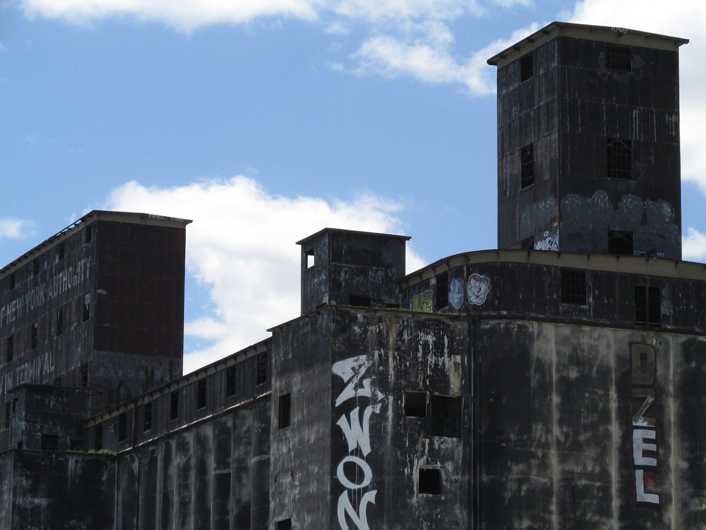 The rooftop towers of the Red Hook Grain Terminal against a blue sky